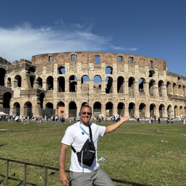 Paul Hutchings standing in front of the Colosseum