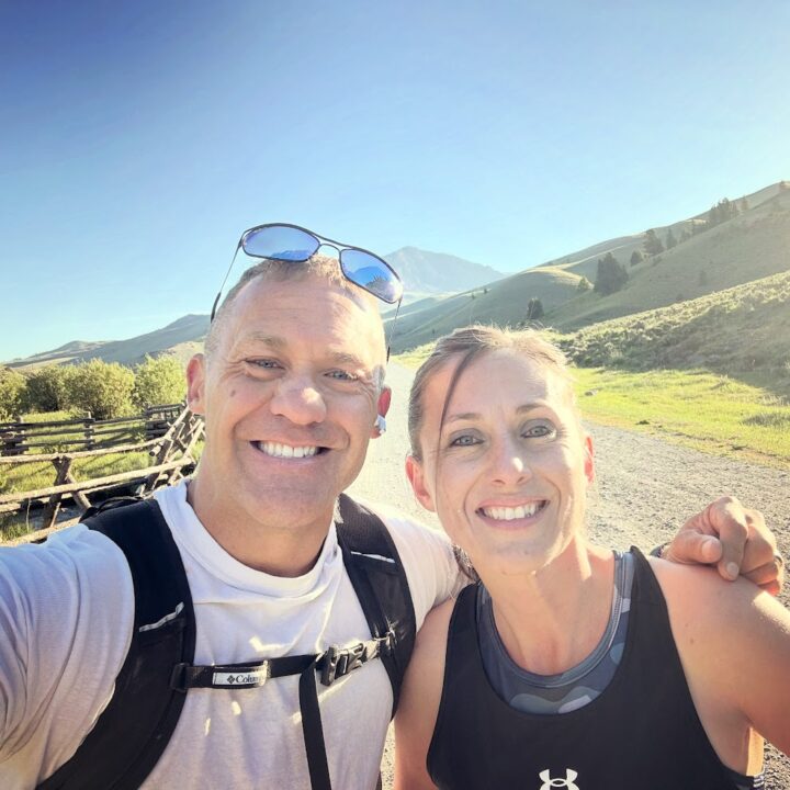 Paul and corene Hutchings taking a selfie on a run in the mountains