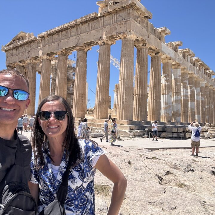 Paul and corene Hutchings taking a selfie in front of the acropolys in Athens