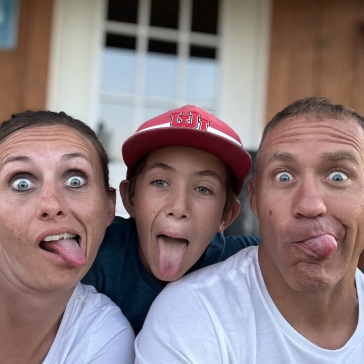 Paul and corene Hutchings making goofy faces with their son