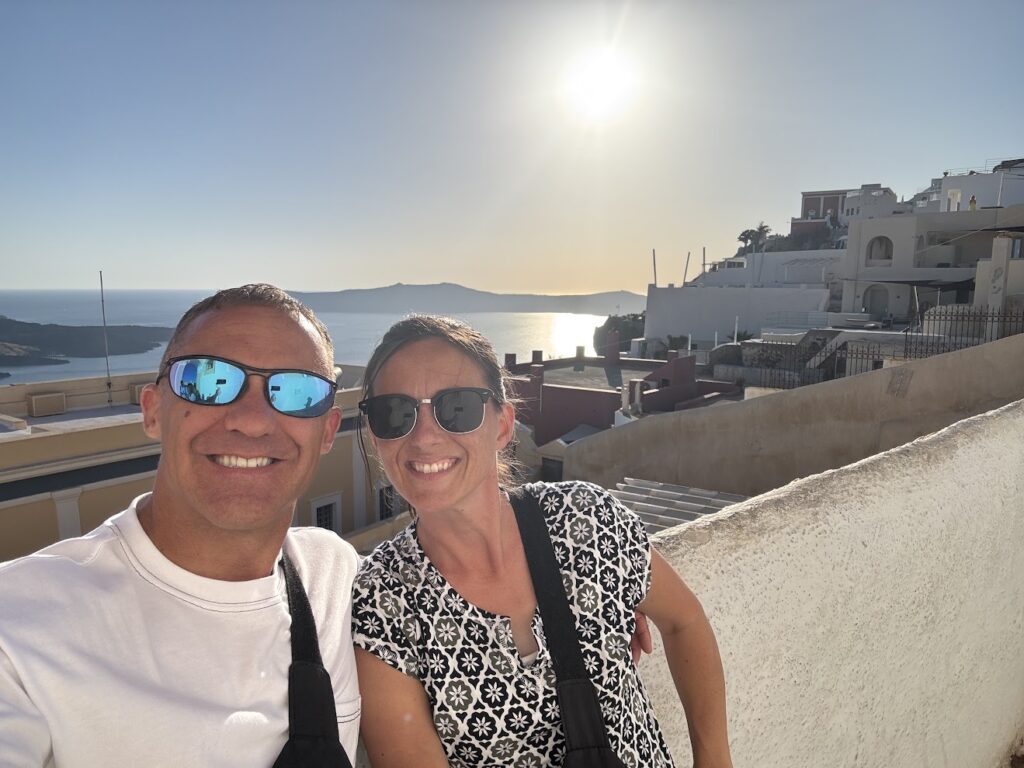 Paul and corene Hutchings taking a selfie at sunset in Santorini.