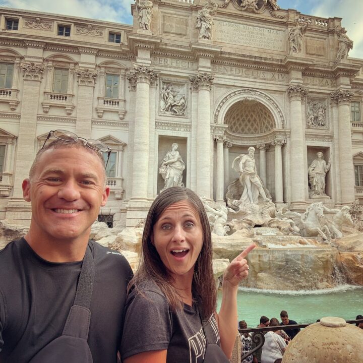 Paul and corene Hutchings posing for a picture in front of a trevi fountain