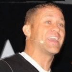 Paul Hutchings head shot with a microphone